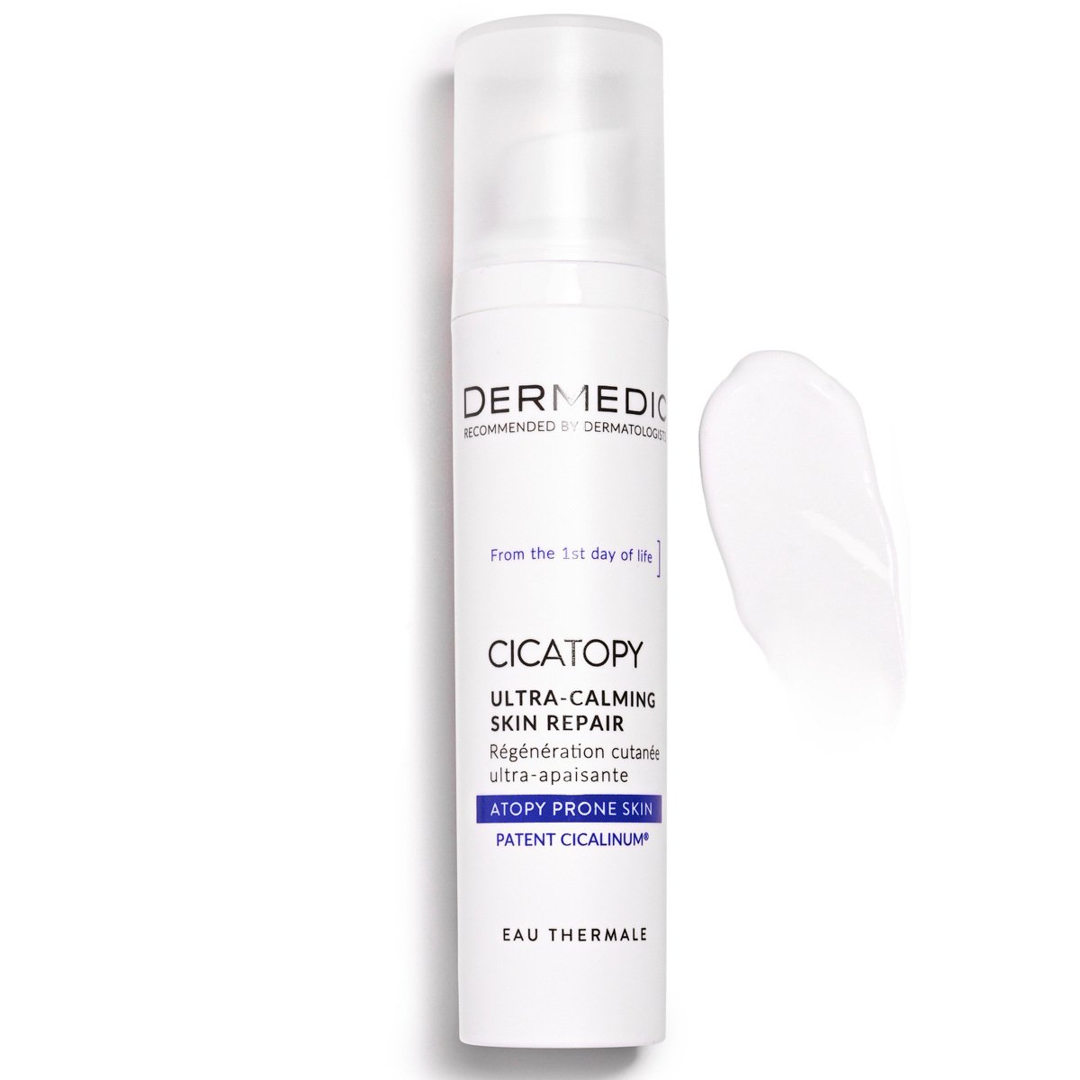A white bottle of Dermedic Cicatopy Ultra-Calming Skin Repair cream stands upright next to a smear of the white product on a white background. The label highlights its use for atopy-prone skin.